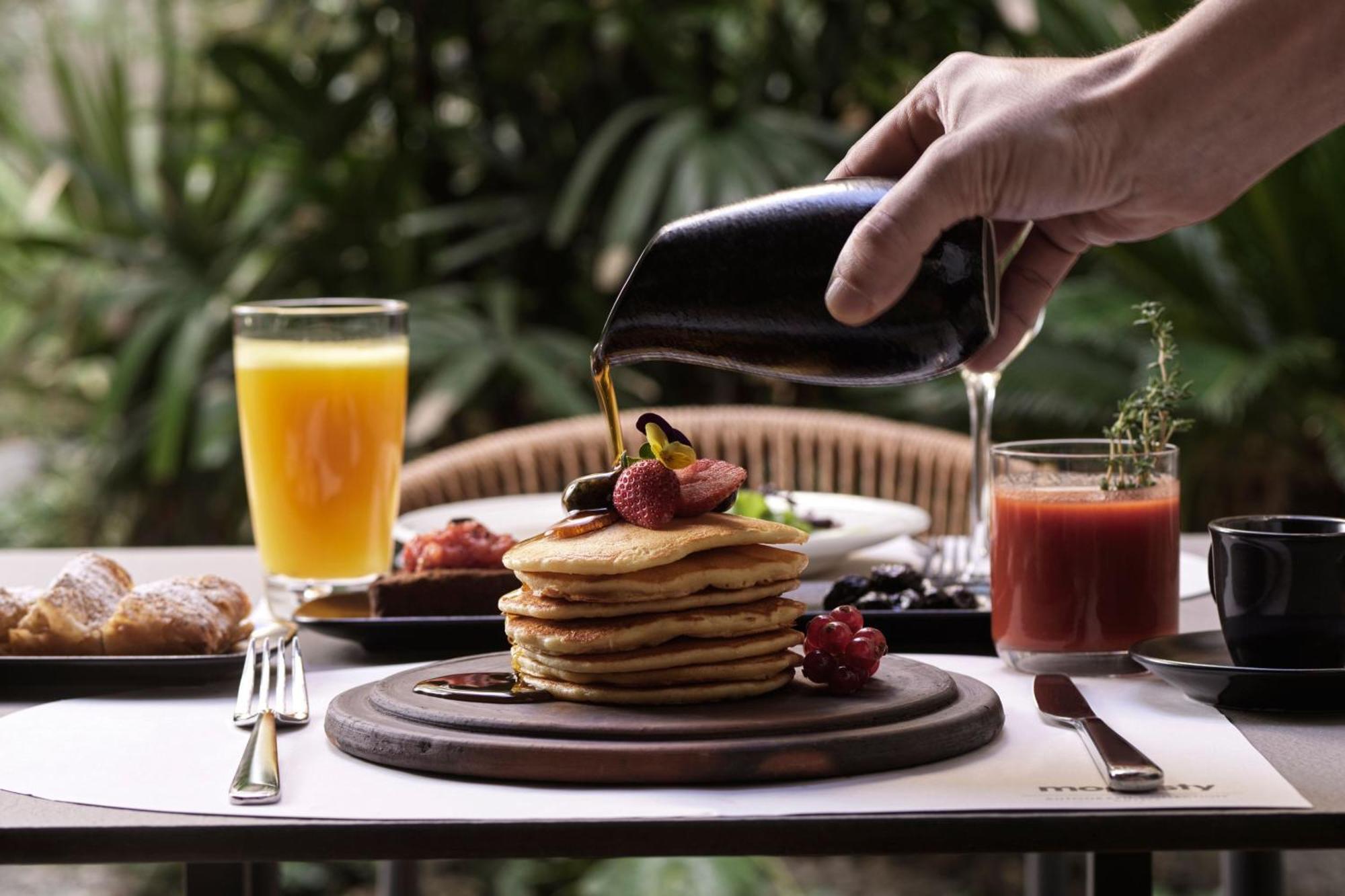 Отель Monasty, Thessaloniki, Autograph Collection Экстерьер фото Maple syrup being poured on a stack of pancakes